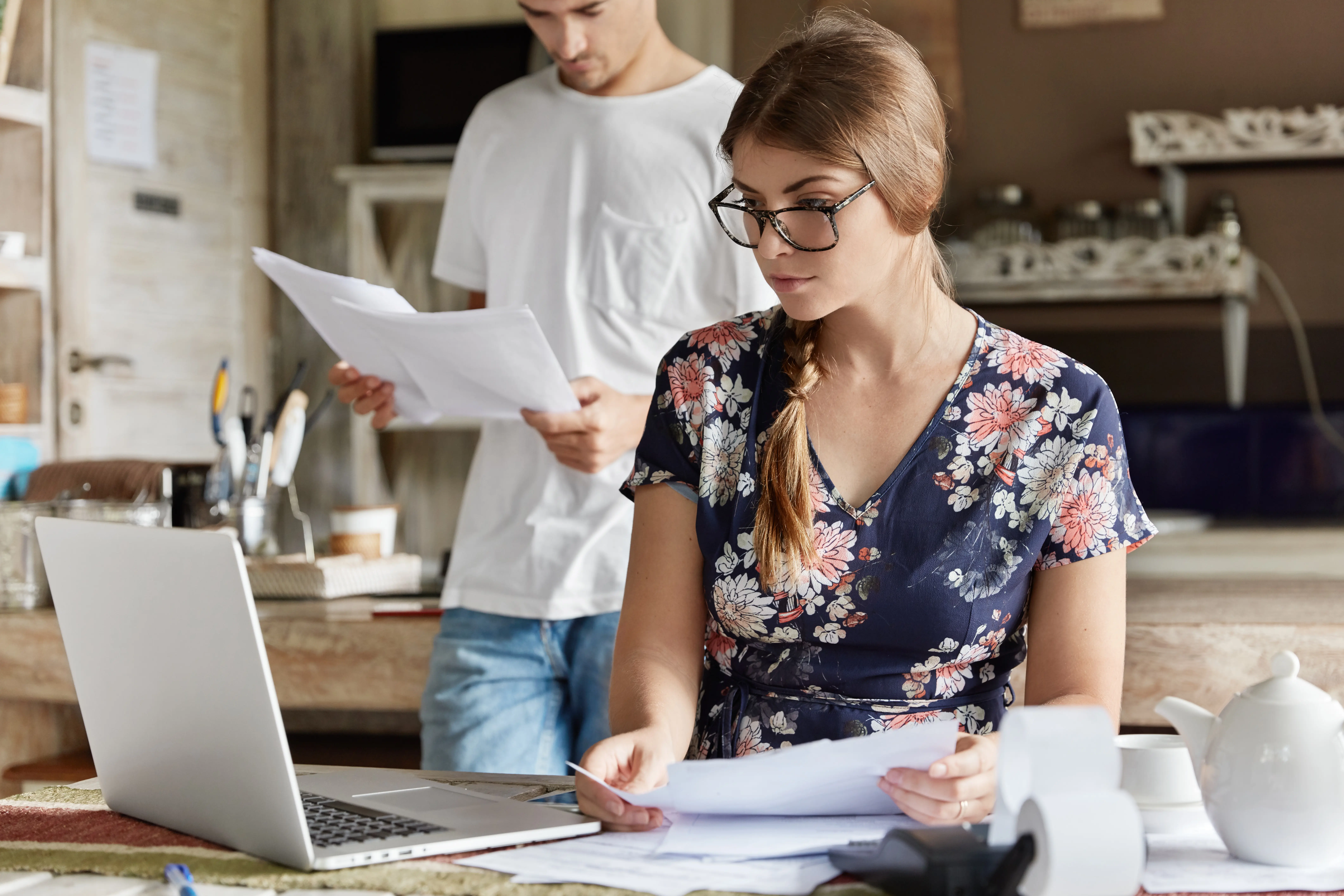 A couple working on their budget together in the kitchen.